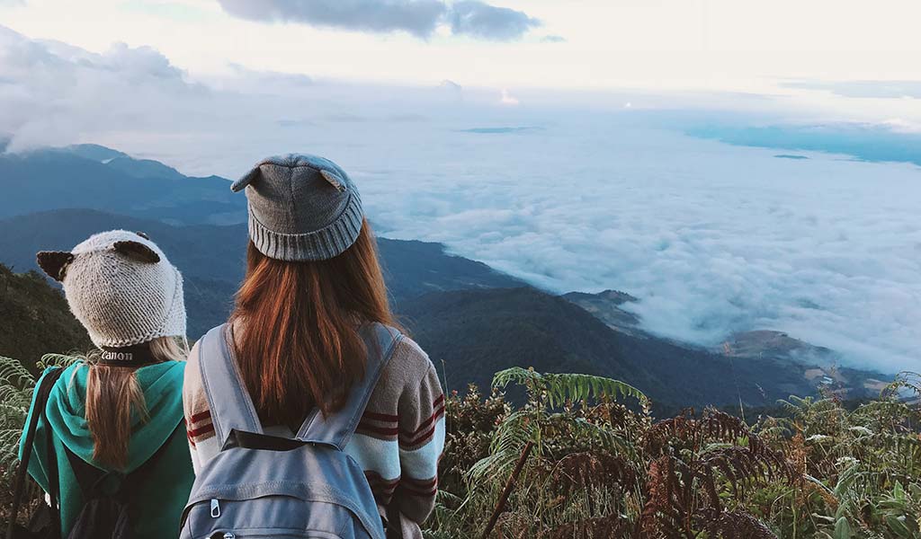 backpack-bonnet-clouds-daylight-foggy-landscape-looking-mountains-outdoors-people-plants-sky-travel-women-1500677